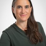 Woman with long black hair and dark shirt